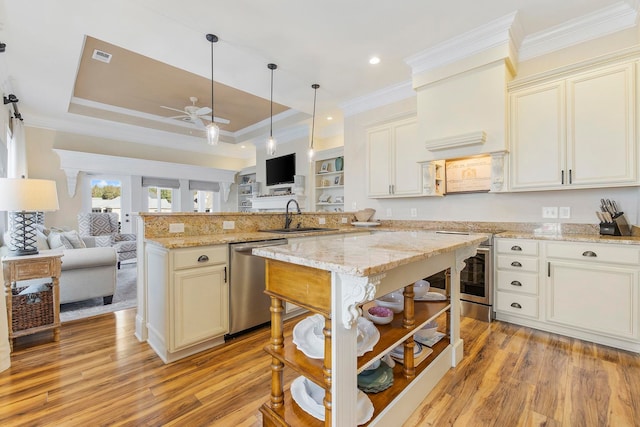 kitchen featuring light hardwood / wood-style flooring, light stone countertops, sink, and stainless steel dishwasher