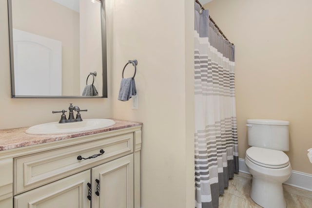 bathroom with vanity, toilet, and tile patterned flooring