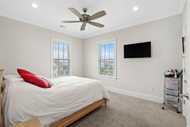 carpeted bedroom featuring ceiling fan and crown molding