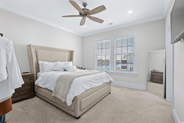 carpeted bedroom featuring ceiling fan and crown molding