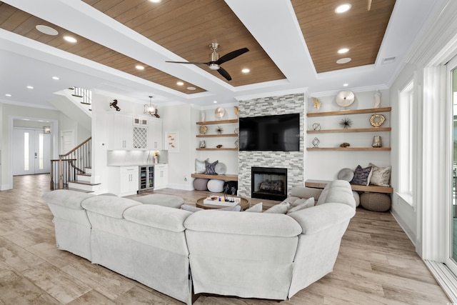 living room with plenty of natural light, wood ceiling, and light hardwood / wood-style flooring