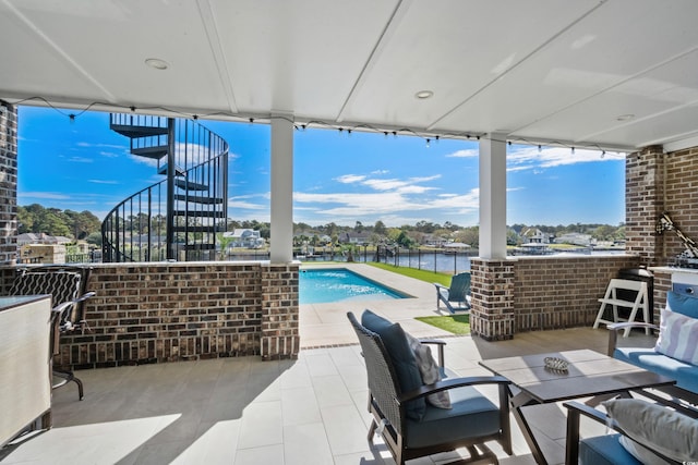 view of patio featuring a water view and a fenced in pool