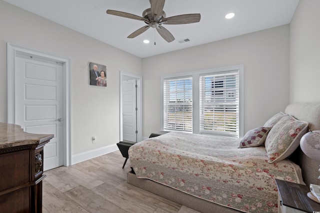 bedroom with ceiling fan and light hardwood / wood-style flooring