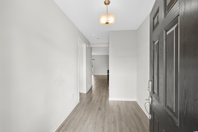 hallway with light hardwood / wood-style floors