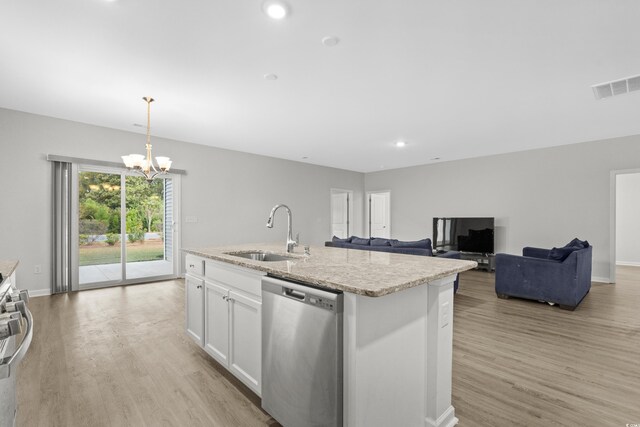 kitchen featuring stainless steel appliances, a center island with sink, sink, white cabinetry, and hanging light fixtures