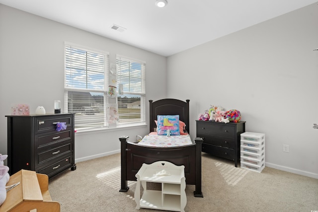 bedroom with light colored carpet