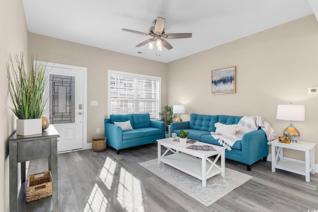 living room featuring hardwood / wood-style flooring and ceiling fan