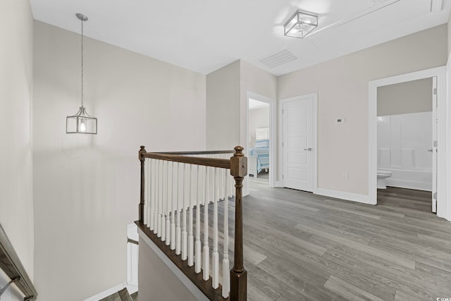 staircase with hardwood / wood-style floors