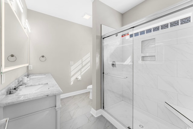 bathroom with vanity, toilet, and an enclosed shower