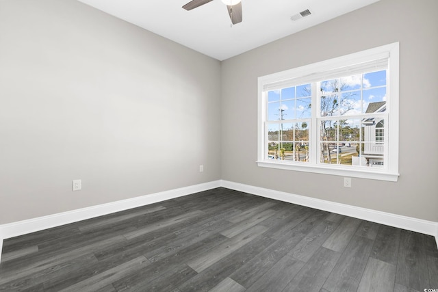 spare room featuring ceiling fan and dark hardwood / wood-style flooring