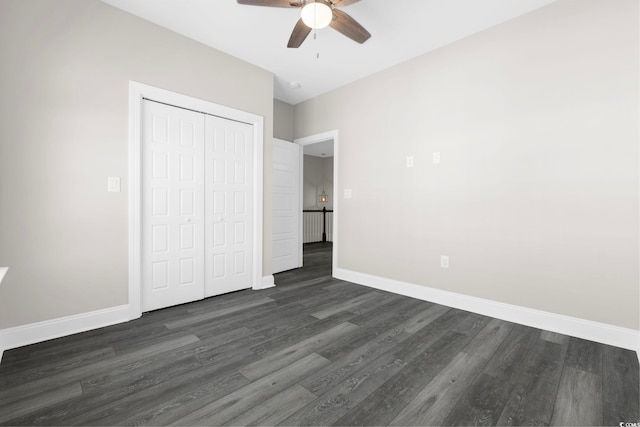 unfurnished bedroom with dark hardwood / wood-style flooring, a closet, and ceiling fan