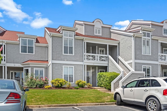 view of property featuring a front lawn