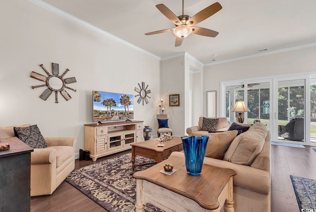 living room with dark wood-type flooring, ceiling fan, and ornamental molding