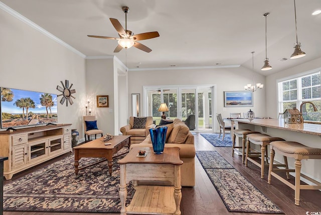 living room with crown molding, ceiling fan with notable chandelier, dark hardwood / wood-style floors, and plenty of natural light