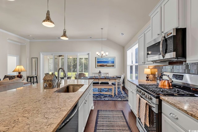 kitchen with stainless steel appliances, hanging light fixtures, a healthy amount of sunlight, and sink