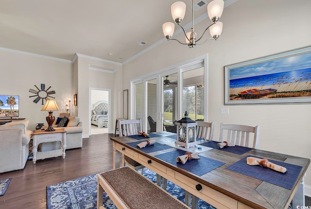 dining space featuring dark hardwood / wood-style floors, crown molding, and a notable chandelier