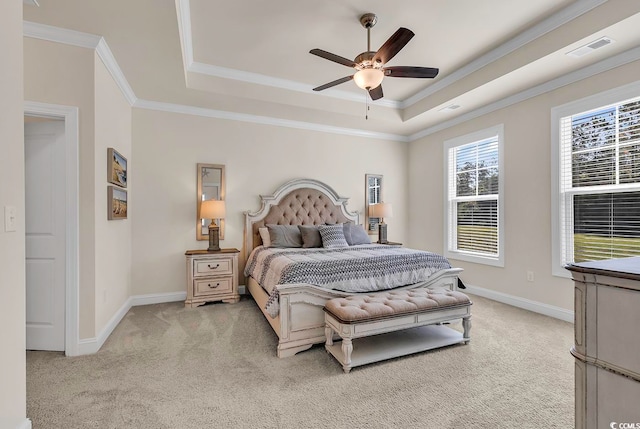 carpeted bedroom featuring ornamental molding, ceiling fan, and a raised ceiling