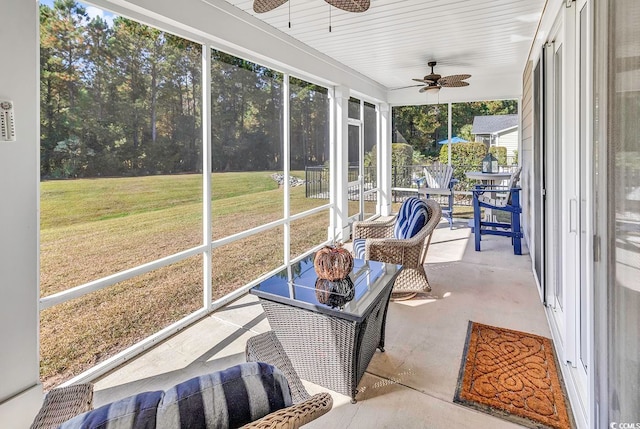 sunroom with a wealth of natural light and ceiling fan