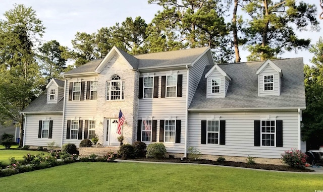 colonial home with a front lawn