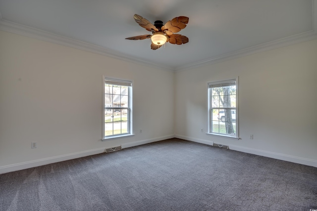 carpeted empty room with ceiling fan, a healthy amount of sunlight, and crown molding