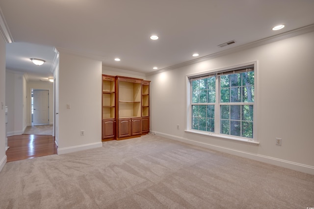 unfurnished living room featuring light carpet and crown molding