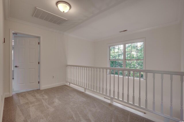 unfurnished room featuring ornamental molding and light carpet