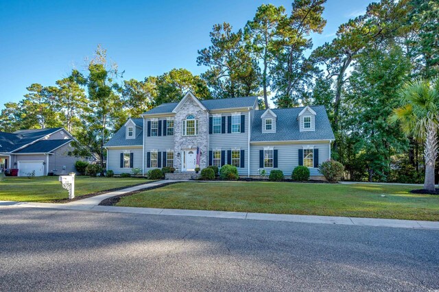 view of front facade featuring a front lawn and a garage