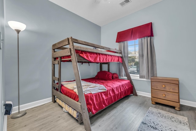 bedroom with hardwood / wood-style flooring and ceiling fan