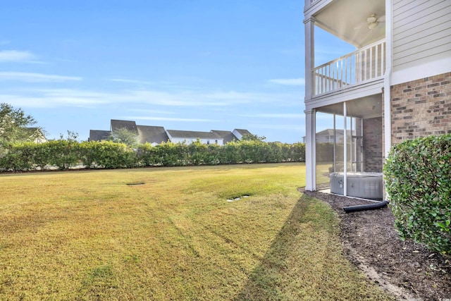 view of yard with a balcony