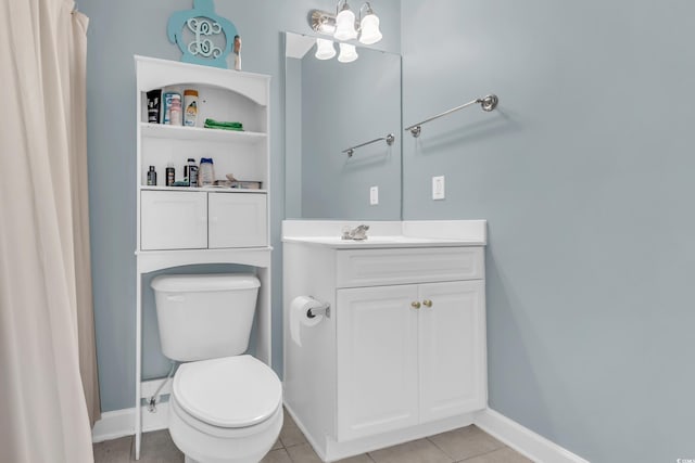 bathroom with tile patterned flooring, vanity, and toilet