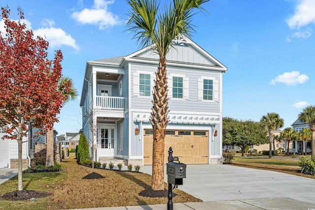 view of front of property featuring a garage, a balcony, and a front yard