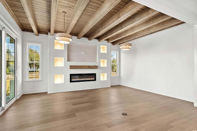 unfurnished living room with beamed ceiling, wooden ceiling, and hardwood / wood-style flooring