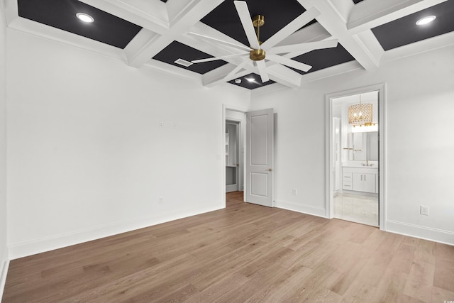 unfurnished bedroom with ensuite bathroom, beam ceiling, light wood-type flooring, and coffered ceiling