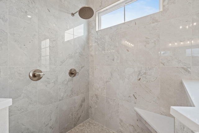 bathroom with tiled shower