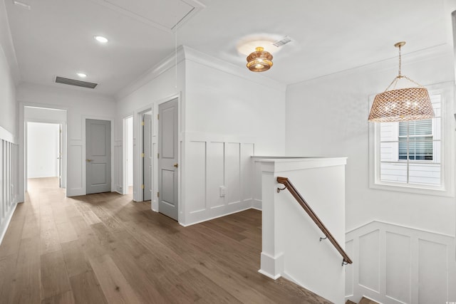 hall featuring wood-type flooring and ornamental molding