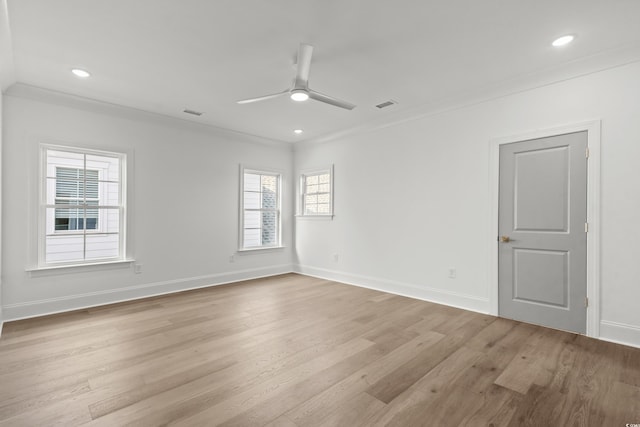 unfurnished room featuring ceiling fan, light wood-type flooring, and ornamental molding