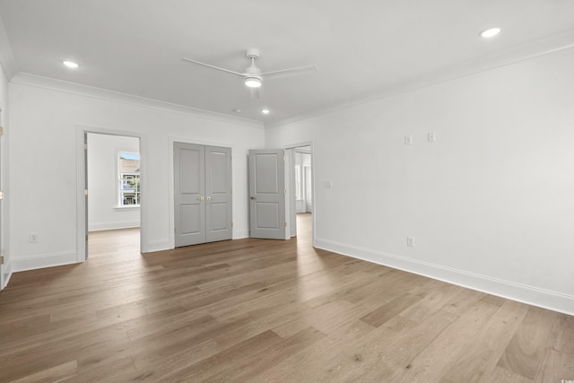 unfurnished bedroom with ceiling fan, crown molding, and light hardwood / wood-style floors