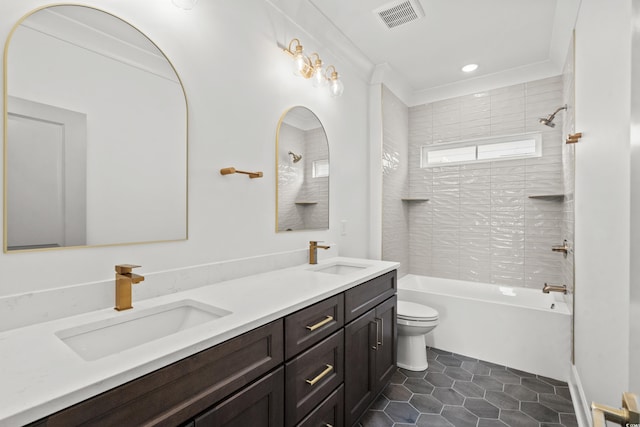 full bathroom featuring tiled shower / bath combo, tile patterned floors, toilet, vanity, and ornamental molding