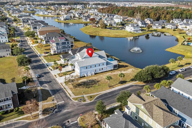 birds eye view of property with a water view