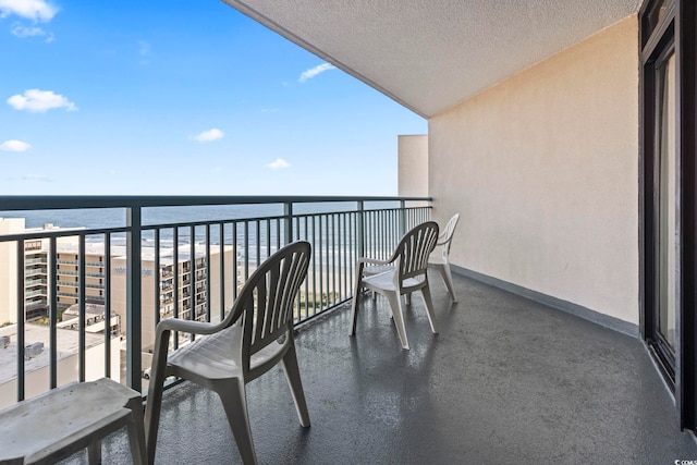 balcony with a beach view and a water view