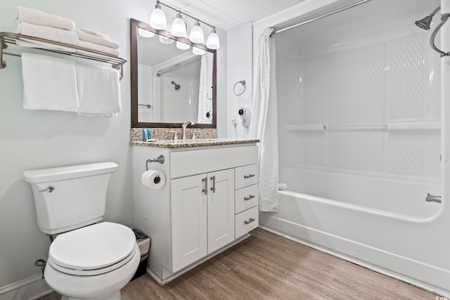 full bathroom featuring hardwood / wood-style floors, vanity, toilet, and shower / tub combo