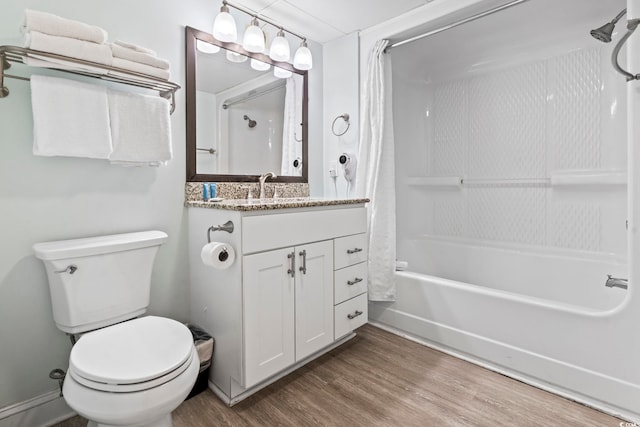 bathroom featuring toilet, vanity, shower / tub combo, and wood finished floors