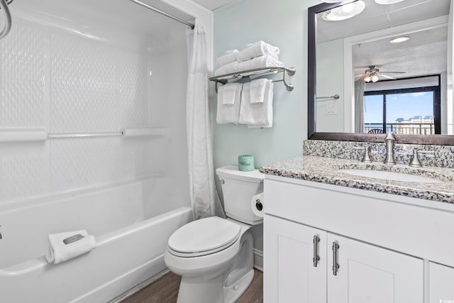 full bath with shower / bath combination with curtain, toilet, wood finished floors, a ceiling fan, and vanity