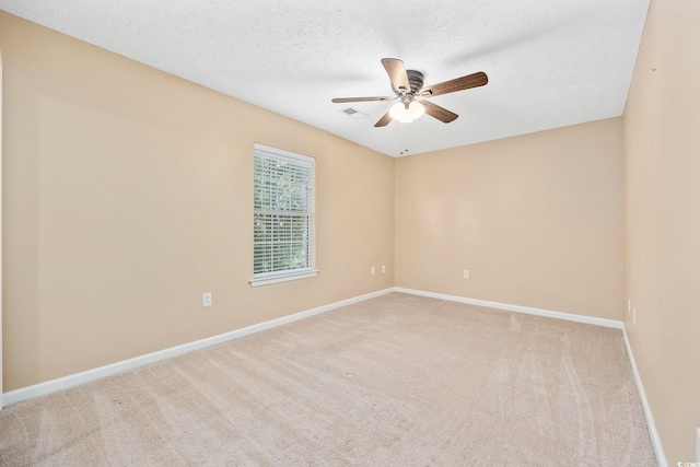 carpeted empty room with a textured ceiling and ceiling fan