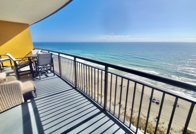 balcony with a water view and a beach view