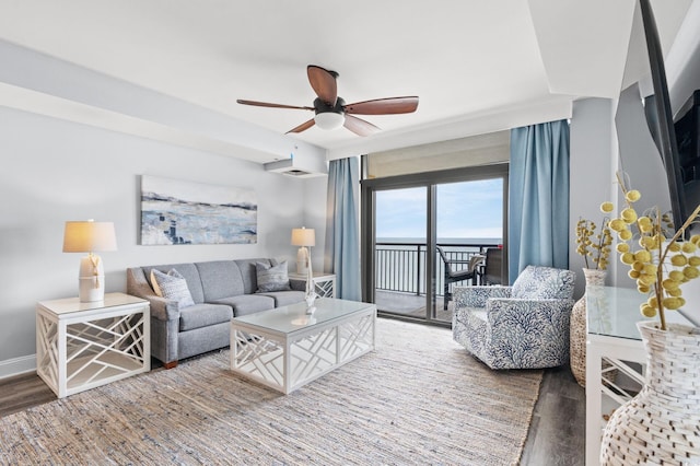 living room with ceiling fan and dark hardwood / wood-style flooring