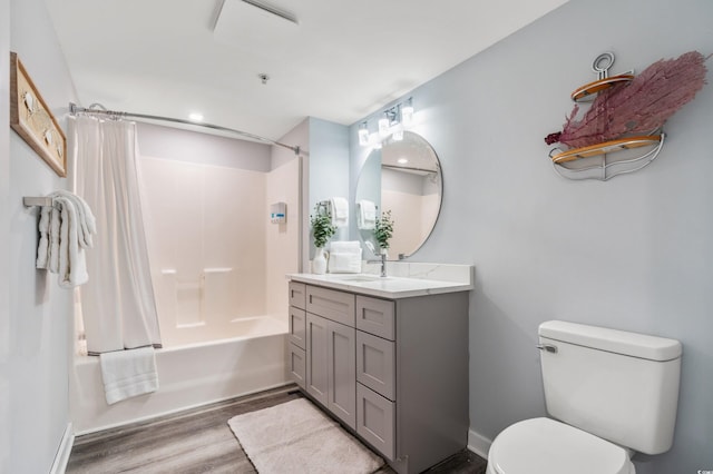 full bathroom featuring hardwood / wood-style flooring, vanity, toilet, and shower / tub combo