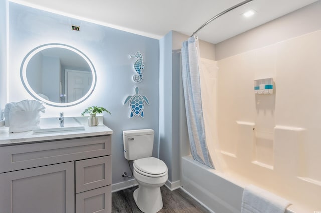 full bathroom featuring hardwood / wood-style floors, vanity, shower / tub combo, and toilet