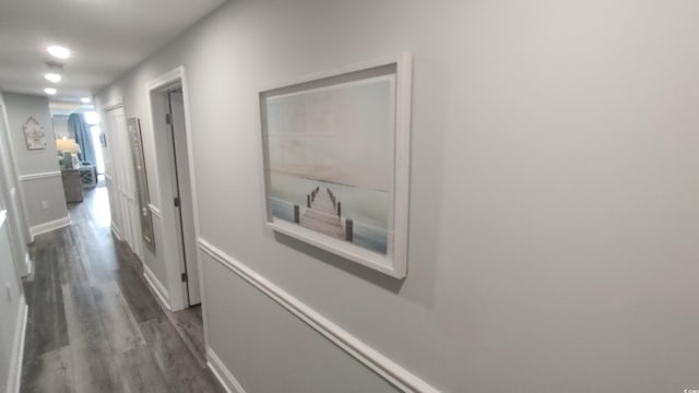 corridor with dark hardwood / wood-style flooring