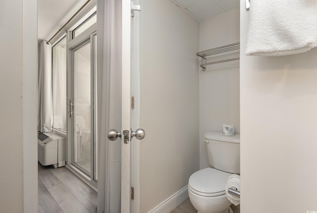 bathroom featuring hardwood / wood-style floors and toilet